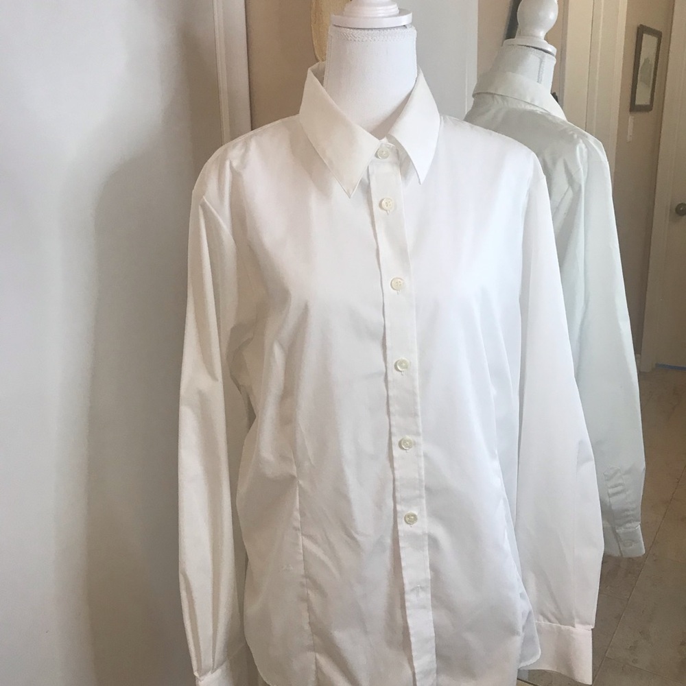 White tailored blouse with button cuff.